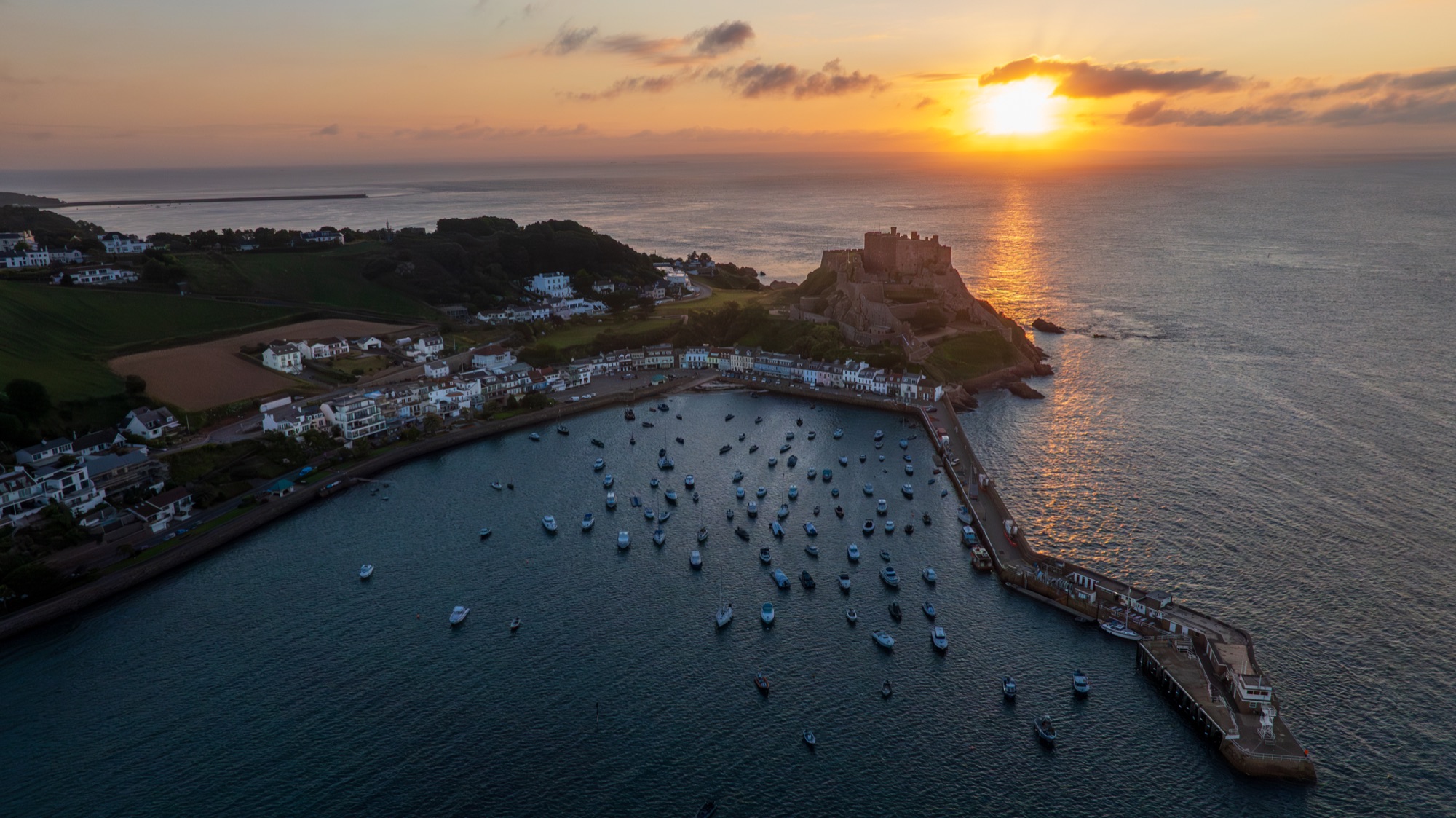Jersey harbour and castle at sunset